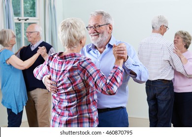 Group Of Seniors Enjoying Dancing Club Together