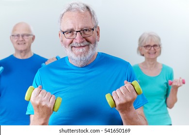 Group Of Seniors In Fitness Class Using Weights