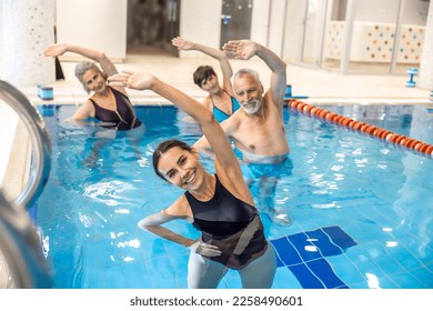 Group of seniors having aqua aerobics class - Powered by Shutterstock