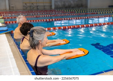 Group of seniors having a swimming class at the swimming pool - Powered by Shutterstock