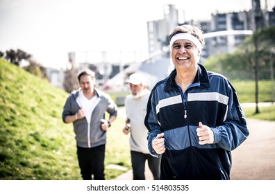 Group of seniors making jogging at the park - Powered by Shutterstock