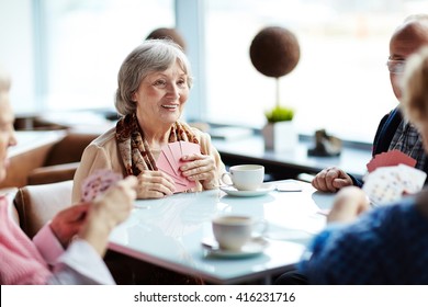 Group Of Seniors Meeting Every Week In Cafe To Play Cards