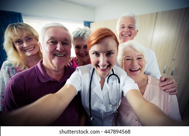 Group Of Seniors With Nurse Doing A Selfie In The Retirement House