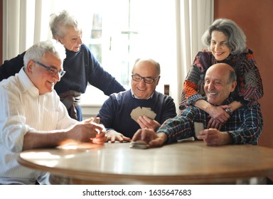 group of seniors play cards