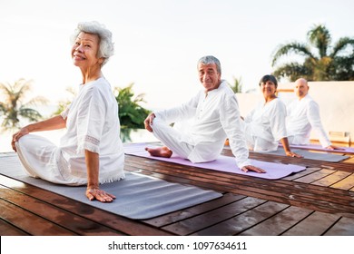 Group Of Seniors Practicing Yoga