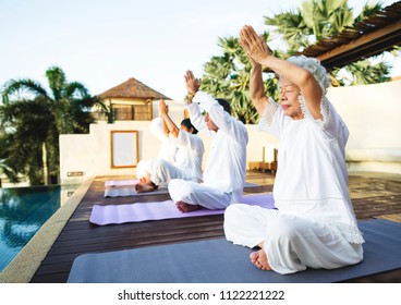 Group Of Seniors Practicing Yoga In The Morning