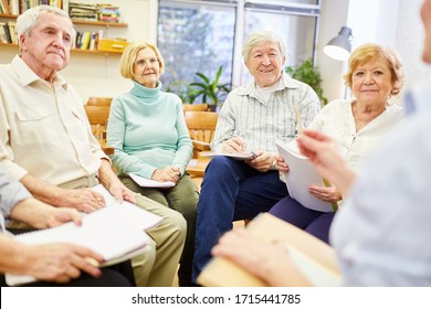 Group Of Seniors With A Psychotherapist In A Discussion Group In The Retirement Home