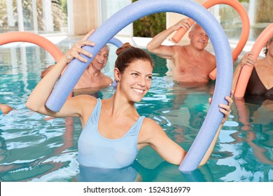 Group of seniors in rehab doing hydrotherapy and water aerobics