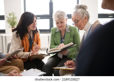 Group Of Seniors With Singing Books Together At Choir Rehearsal.