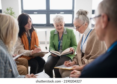 Group Of Seniors With Singing Books Together At Choir Rehearsal.