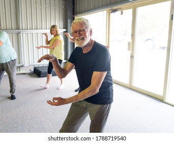 Group Of Seniors In Tai Chi Class Exercising In An Active Retirement Lifestyle. Mental And Physical Health Benefits Of Exercise And Fitness In Elderly People. Senior Health Care And Wellbeing Concept.