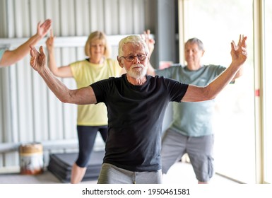 Group Of Seniors In Tai Chi Class Exercising In An Active Retirement Lifestyle. Mental And Physical Health Benefits Of Exercise And Fitness In Elderly People. Senior Health Care And Wellbeing Concept.