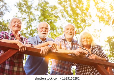 Group Of Seniors Taking A Break While Hiking In The Summer