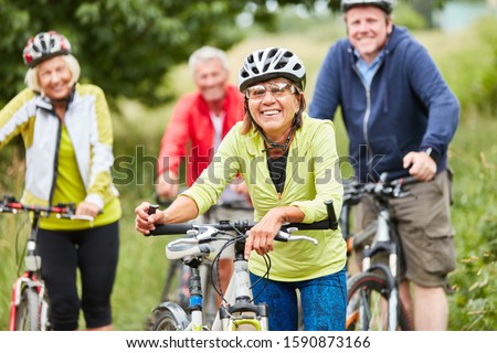 Group of seniors together while cycling in the nature on a bike tour