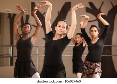 Group of serious ballet dance students performing
