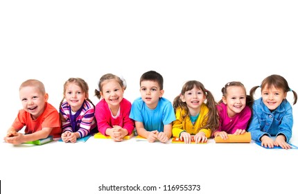 Group of seven children are lying on floor with copybooks together - Powered by Shutterstock