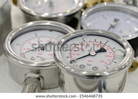 Group of several assorted mechanical pressure gauges. Close up shot, selective focus, abstract technology background.