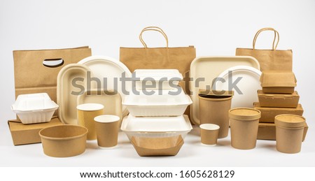 Group shot of biodegradable and recyclable food packaging on white background, paper plates, cups, containers, bags, no logos