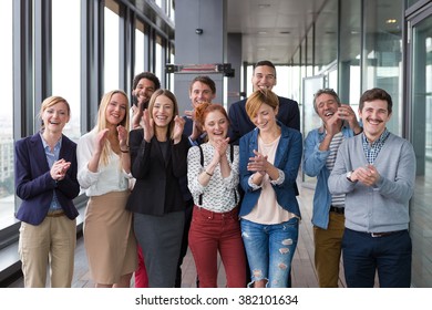 Group shot of business people in modern office hall. - Shutterstock ID 382101634