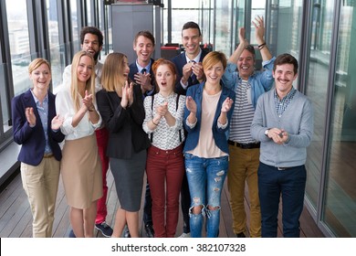 Group shot of business people in modern office hall. - Shutterstock ID 382107328