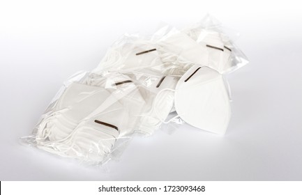 Group Of Simple White Protective KN95 Face Masks In Plastic Packages New Anti Viral Safety Protection Masks With An Adjustable Metal Nose Piece On White Background, Bulk Buying Studio Product Shot