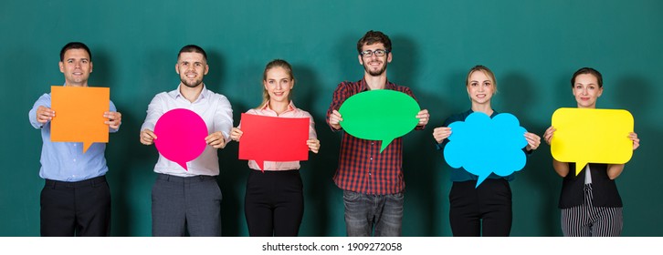 Group Of Six Business People Team Standing Together And Holding Colorful And Different Shapes Of Speech Bubbles.