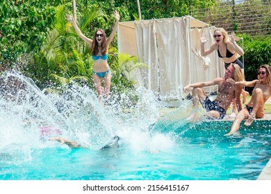 group of six friends having fun in swimmingpool outdoors