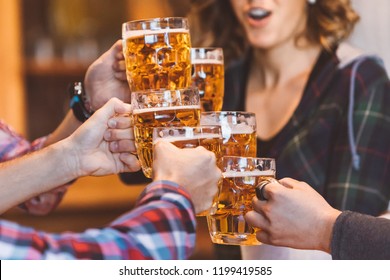 Group Of Six Friends Wowing And Making Cheers With Beer Pints. People Drinking Beer, Having Fun, Celebrating, Meeting And Smiling.