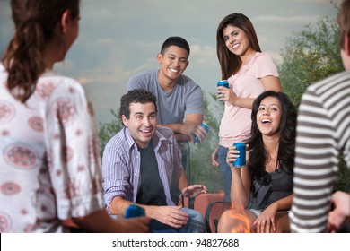 Group Of Six Happy Young People Socialize Outside