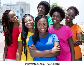 Group of six laughing african american woman in colorful shirts