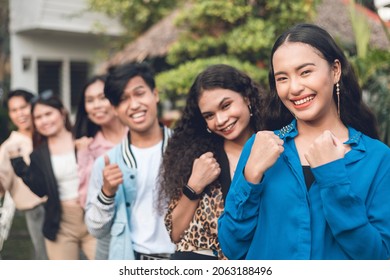 A group of six young and dynamic friends from late teens to early 20s, making gestures of success. Outdoor scene. - Shutterstock ID 2063188496