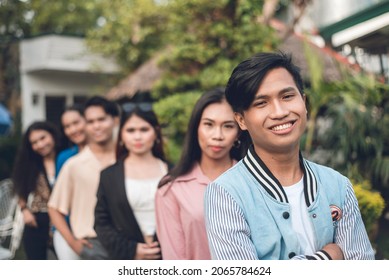 A Group Of Six Young And Dynamic Friends From Late Teens To Early 20s, In A Single File. Outdoor Scene.