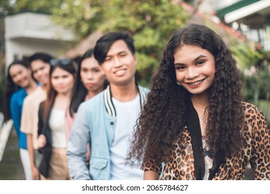 A Group Of Six Young And Dynamic Friends From Late Teens To Early 20s, In A Single File. Outdoor Scene.