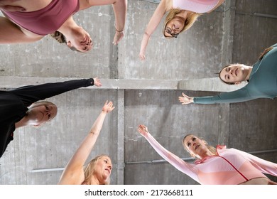 Group Of Six Young Motivated Sporty Girls Wearing Sports Attire Standing Together Forming Hand Stack Before Workout In Fitness Class. High Quality Photo