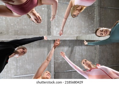 Group Of Six Young Motivated Sporty Girls Wearing Sports Attire Standing Together Forming Hand Stack Before Workout In Fitness Class. High Quality Photo