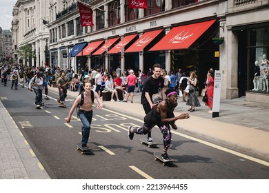 A Group Of Skaters Proceed Down Regents Street, London, Outside Hamleys Toy Store. 