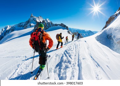 A group of skiers start the descent of Valle Blanche, the most famous offpist run in the Alps, Valle Blanche descent links Italy and France through the Mont Blanc Massif. Chamonix, France, Europe. - Powered by Shutterstock