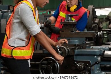 Group of skillful workers using machine equipment in factory workshop . Industry and engineering people technology concept .