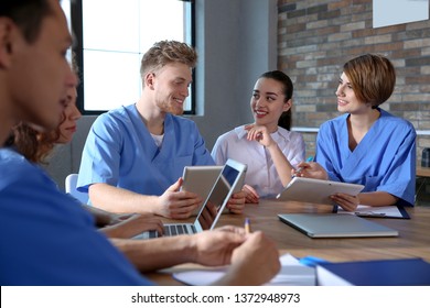 Group of smart medical students with gadgets in college