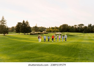 Group of smiling attractive multicultural friends, successful international students meeting, walking in park. Happy tourists together on vacation, copy space. Diversity, friendship, travel concept - Powered by Shutterstock