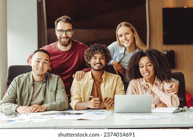 Group of smiling confident multiracial university students studying together looking at camera in university campus, education concept.	Portrait of young successful startup team in modern office   - Powered by Shutterstock