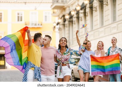 Group Of Smiling Different People On A Lgbt Community Parade Walking On A Street