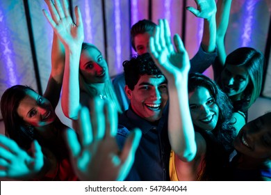 Group of smiling friends dancing on dance floor in bar - Powered by Shutterstock