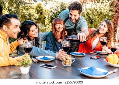 Group of smiling friends enjoying dinner party at backyard at ho - Shutterstock ID 2255790003