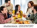 Group of smiling friends toasting red wine at dinner at home - Happy family having dining party together bar restaurant - Lifestyle concept with guys and girls eating meal and drinking