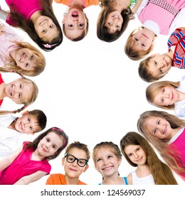 Group Of Smiling Kids Standing In Huddle On White Background