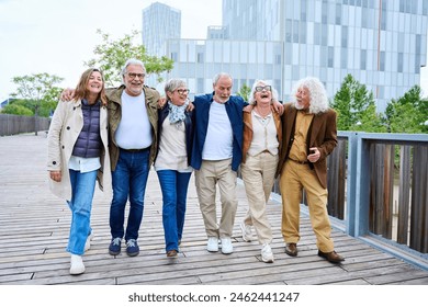 Group of smiling mature people walking carefree. Senior enjoy vacations on street of urban park city. Diverse happy elderly friends having fun celebrating leisure time hugging. Caucasian Gray hair - Powered by Shutterstock