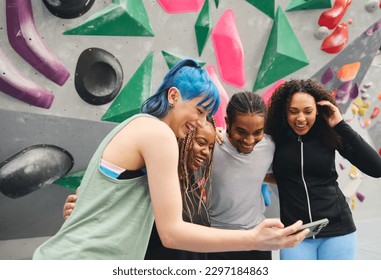 Group of smiling multi-cultural friends looking at for selfie by climbing wall at indoor activity centre - Powered by Shutterstock