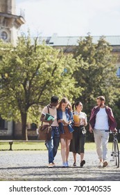 Group Of Smiling Multicultural Students Walking In Park Together