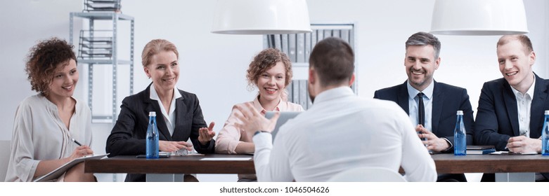 Group Of Smiling Recruiters Listening To A Man With Good References